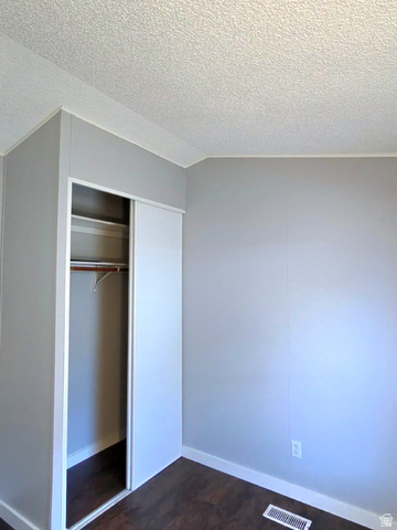 1525 South 400 East, Unit 63 Springville, UT 84663 - Photo 19 of 36 Unfurnished bedroom featuring dark wood-type flooring and a closet