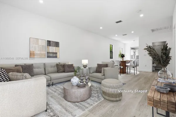 a living room with furniture and a large window