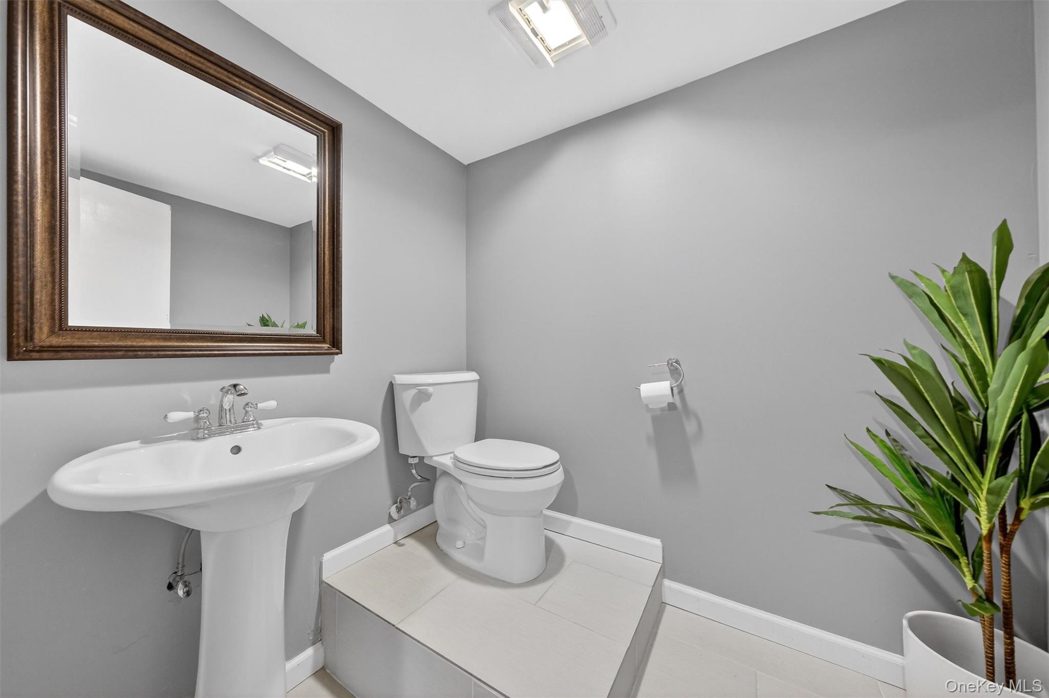 21 Russo Road Hopewell Junction, NY 12533 - Photo 29 of 41 a bathroom with a toilet a sink and mirror