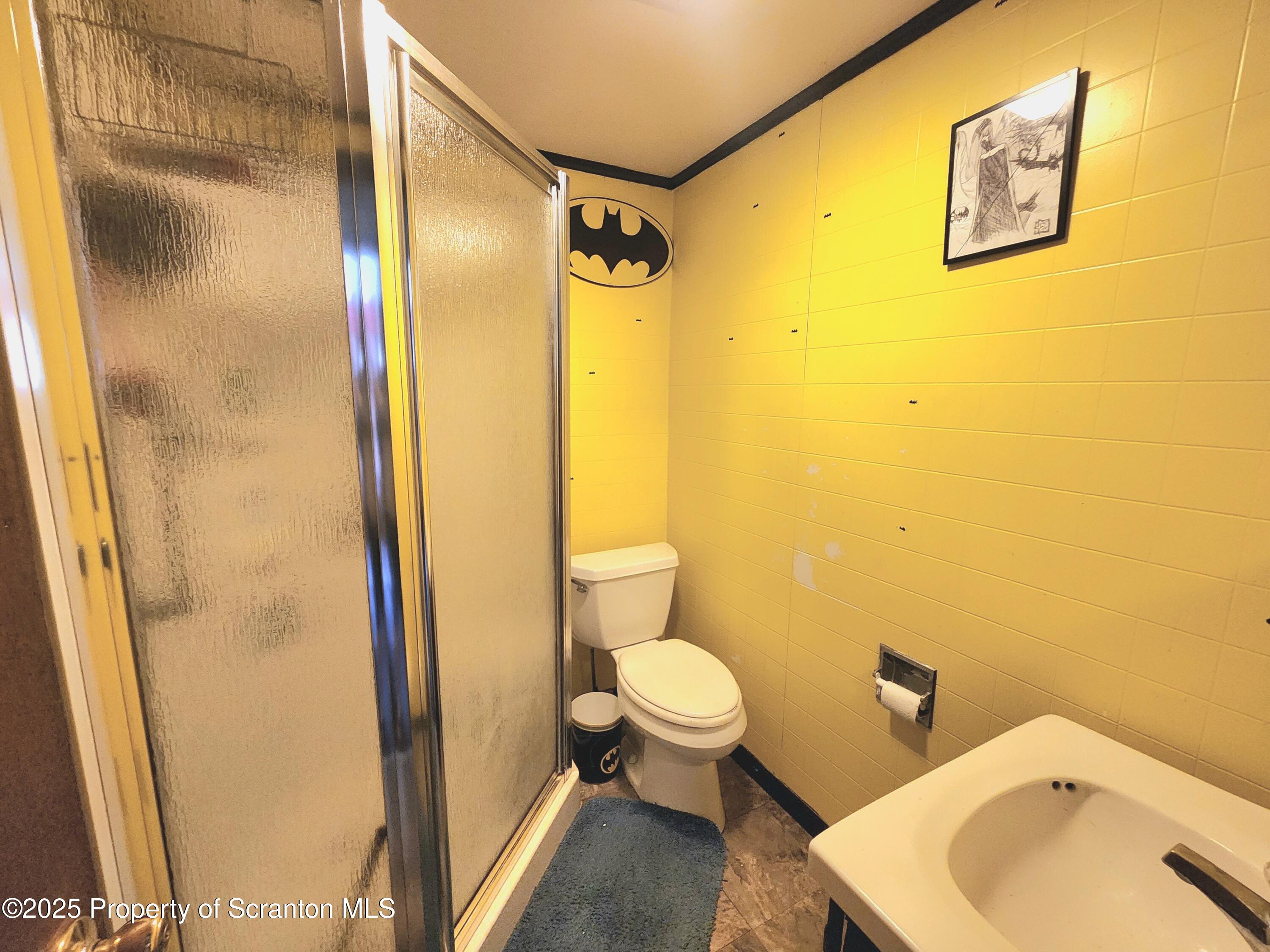 365 Carpenter Road Factoryville, PA 18419 - Photo 19 of 30 a bathroom with a sink and mirror with toilet