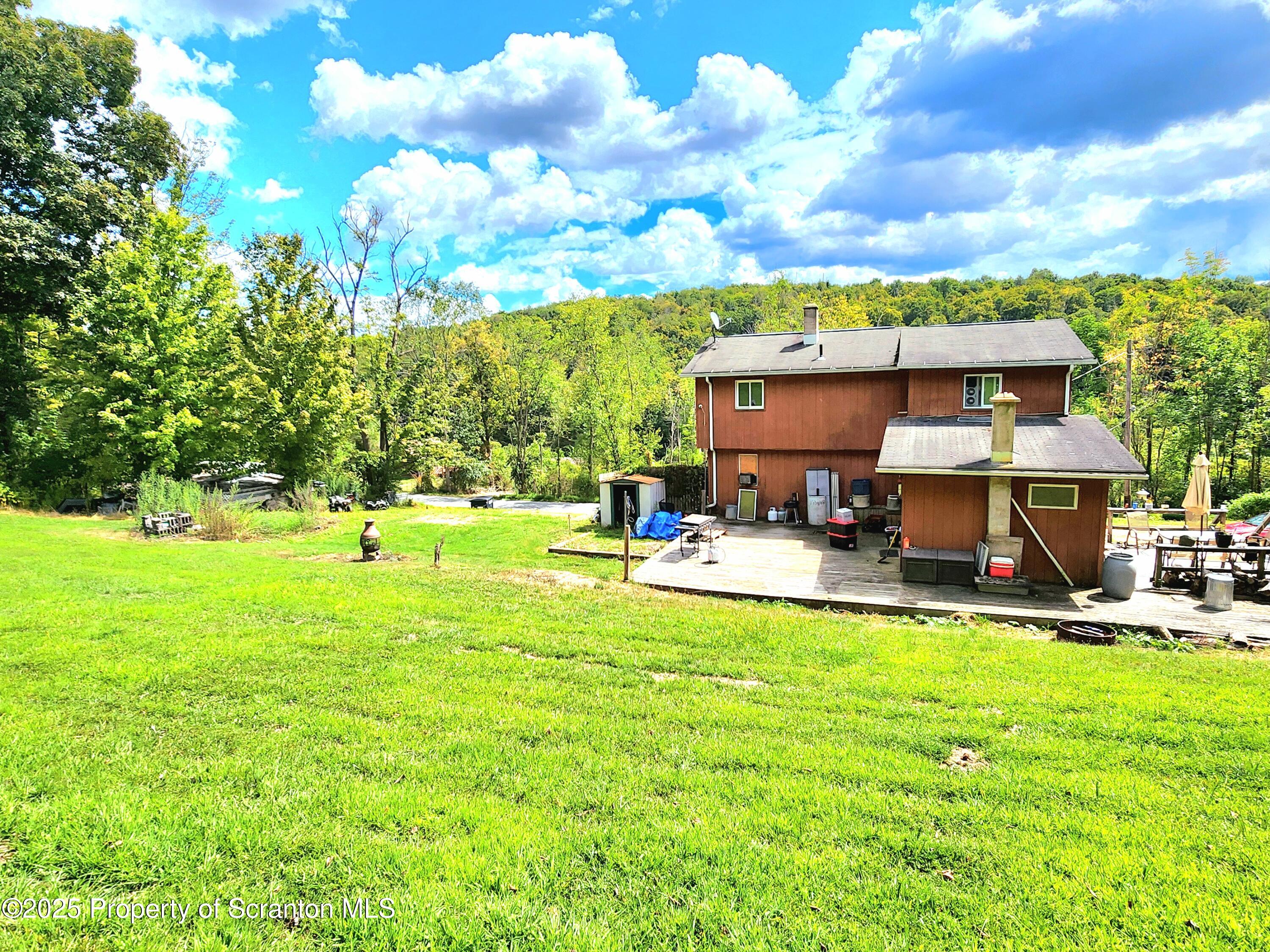 365 Carpenter Road Factoryville, PA 18419 - Photo 24 of 30 a view of a swimming pool with lawn chairs and a big yard