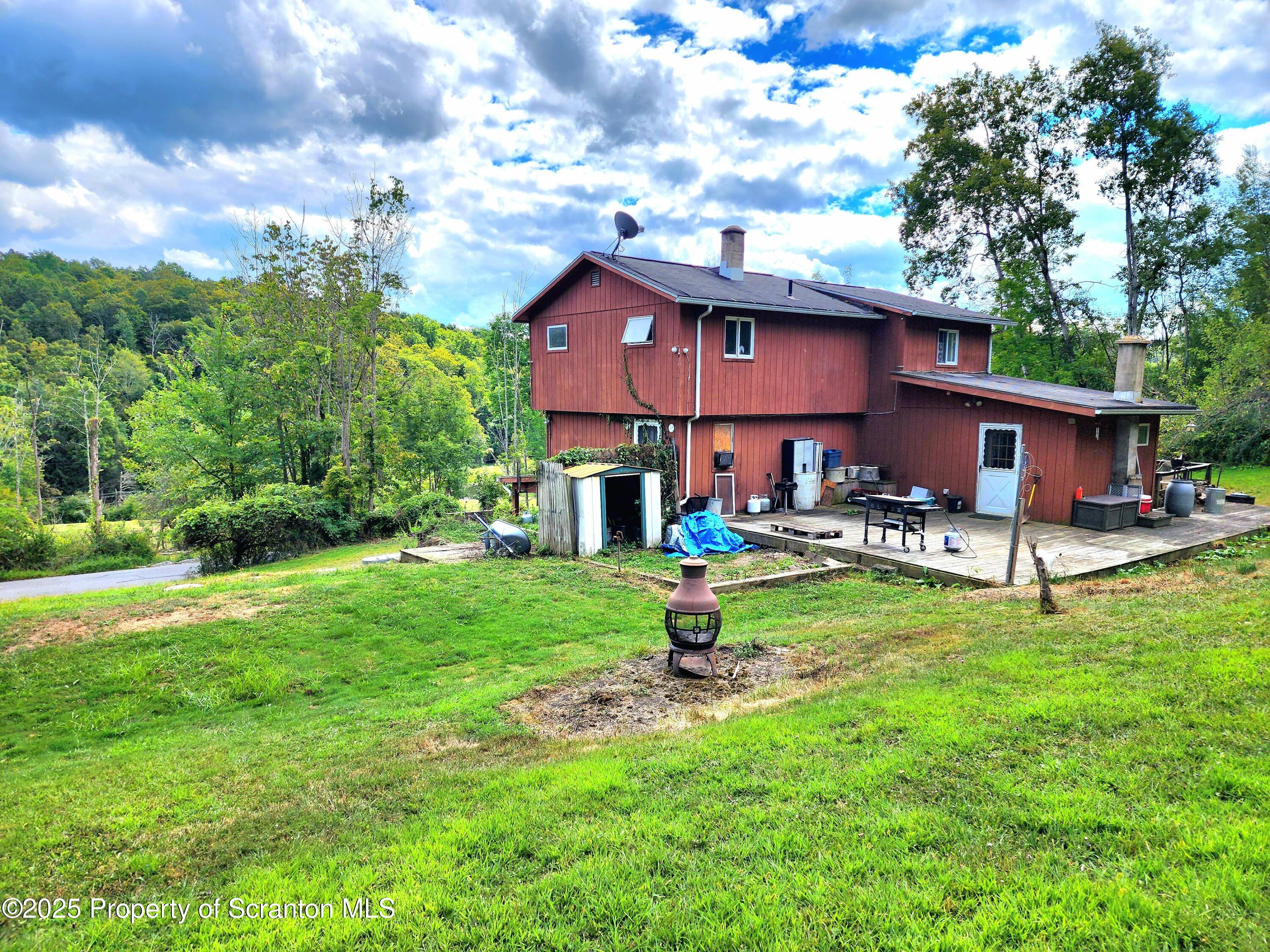 365 Carpenter Road Factoryville, PA 18419 - Photo 26 of 30 a view of a house with a yard and sitting area