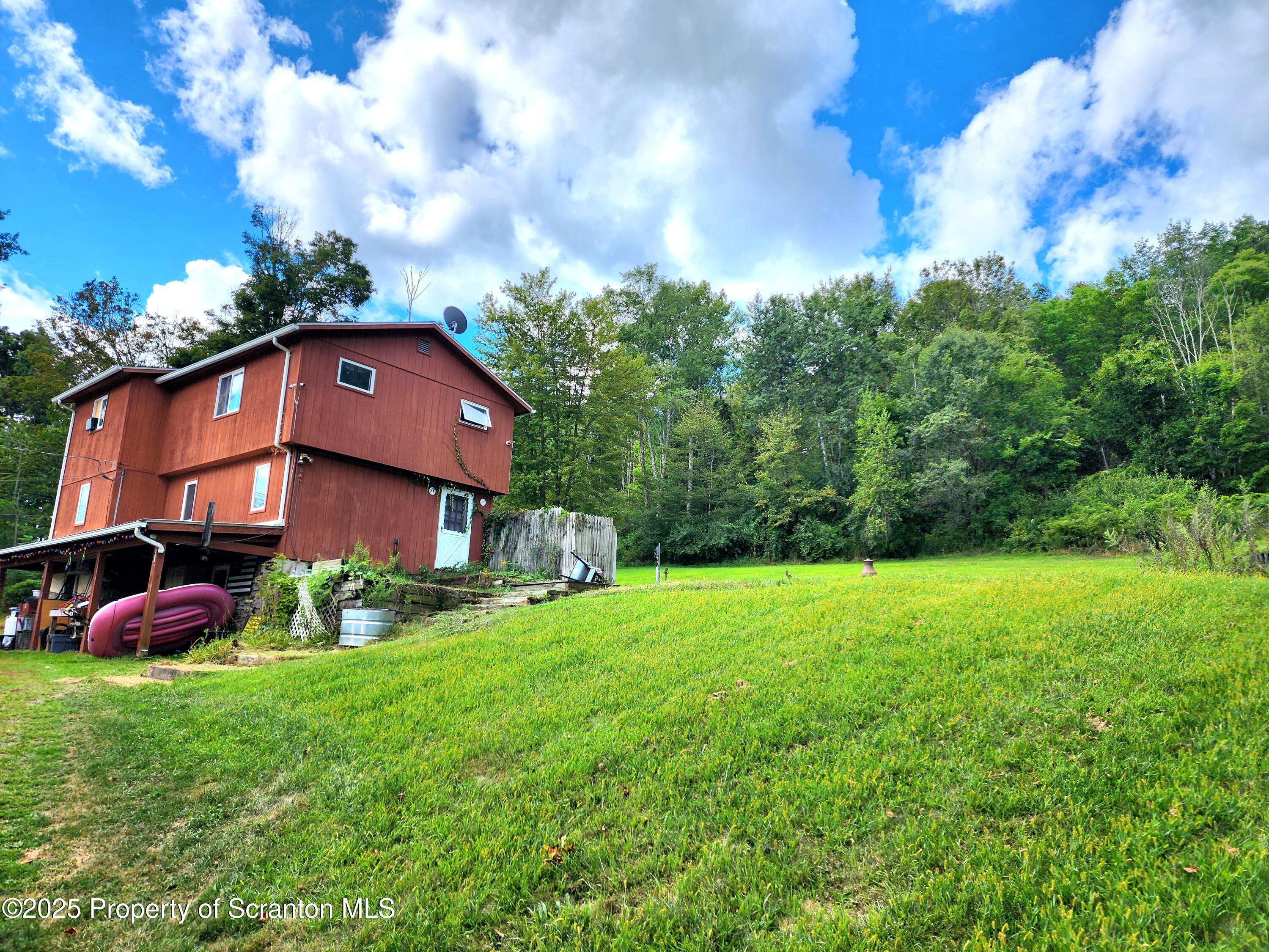 365 Carpenter Road Factoryville, PA 18419 - Photo 27 of 30 a view of a yard in front of a house with a large tree