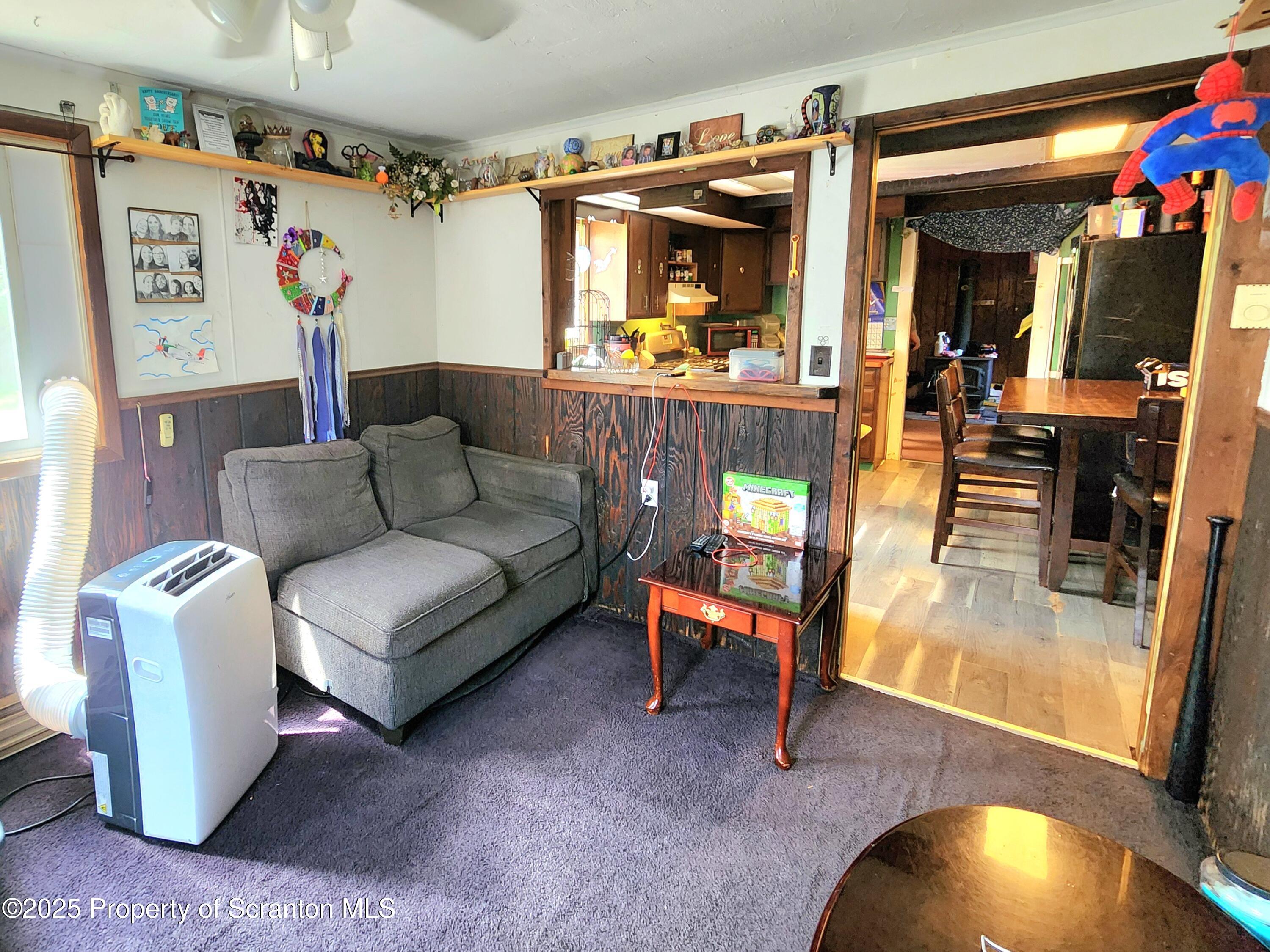 365 Carpenter Road Factoryville, PA 18419 - Photo 5 of 30 a living room with furniture and a floor to ceiling window