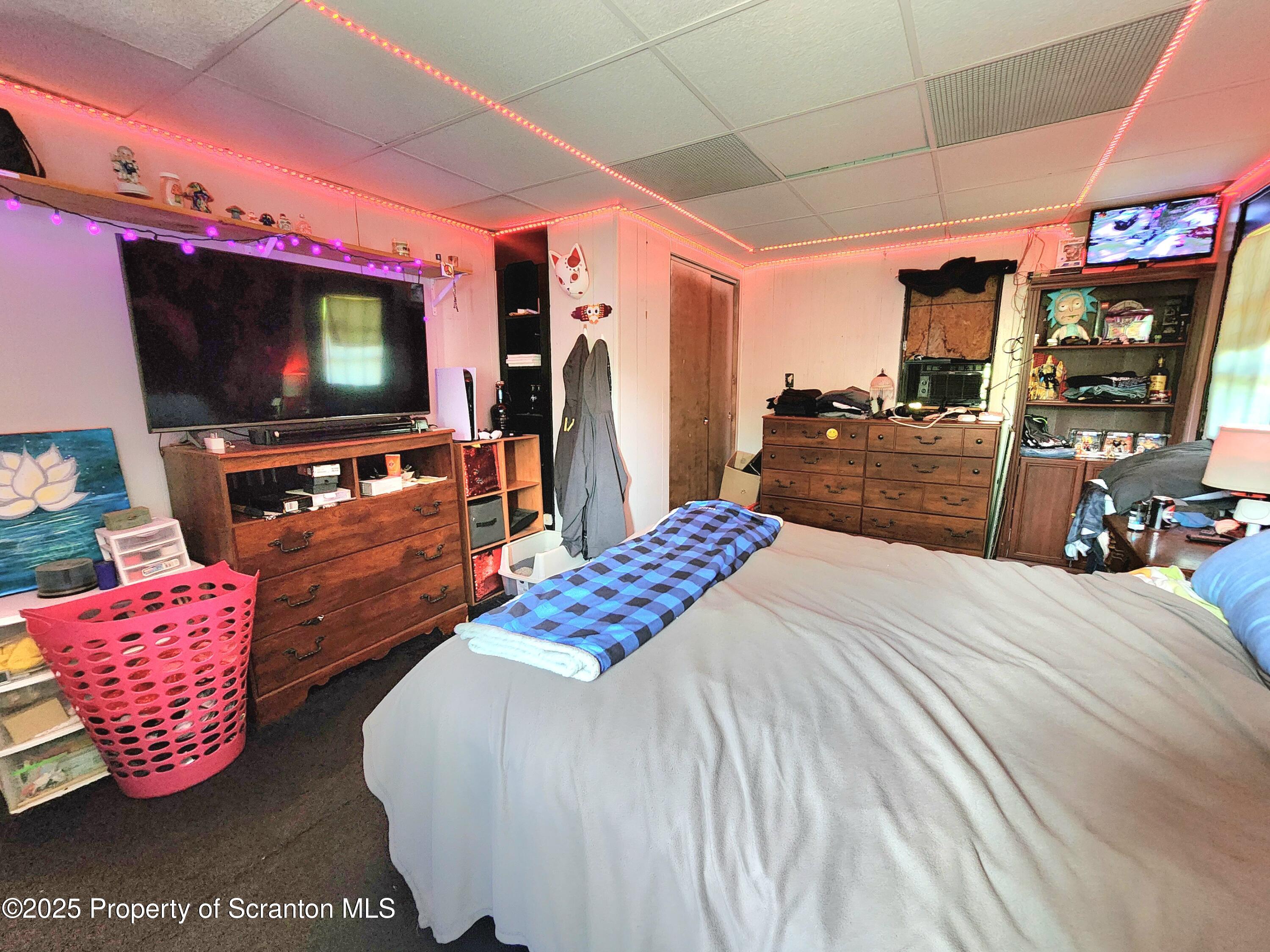 365 Carpenter Road Factoryville, PA 18419 - Photo 7 of 30 a bedroom with a bed and flat screen tv