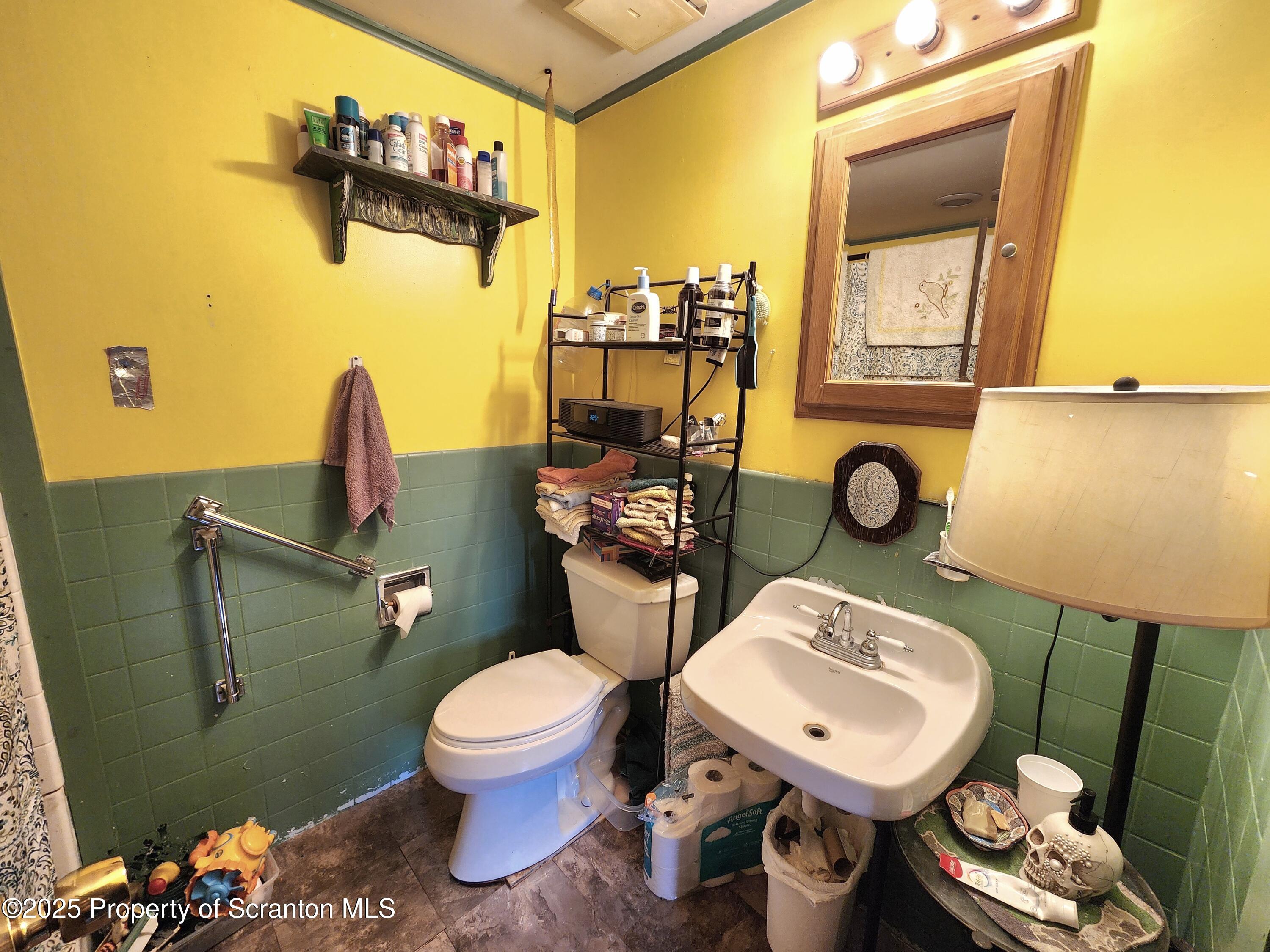 365 Carpenter Road Factoryville, PA 18419 - Photo 8 of 30 a bathroom with a toilet sink and mirror