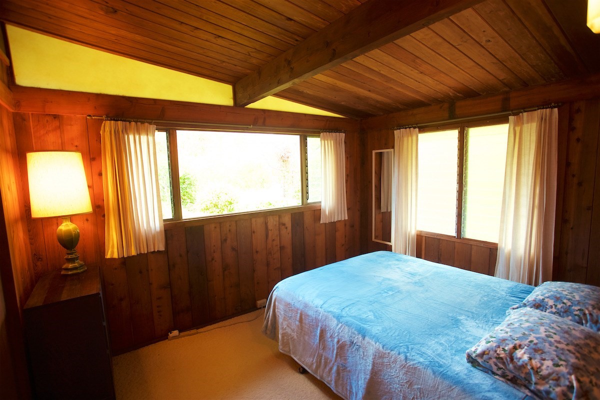 19-4096 Wright Road Volcano, HI 96785 - Photo 14 of 23 a bedroom with a bed and wooden floor