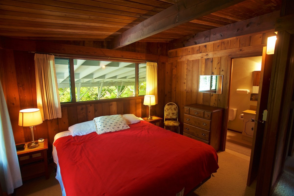 19-4096 Wright Road Volcano, HI 96785 - Photo 17 of 23 a bedroom with a bed and wooden floor