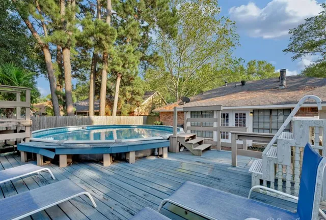 a view of a house with wooden deck and furniture