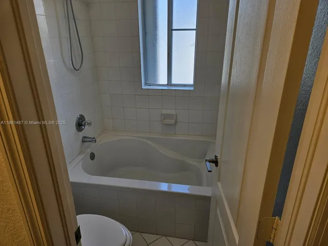a bathroom with a tub and a shower