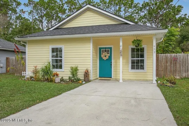 a front view of a house with a garden