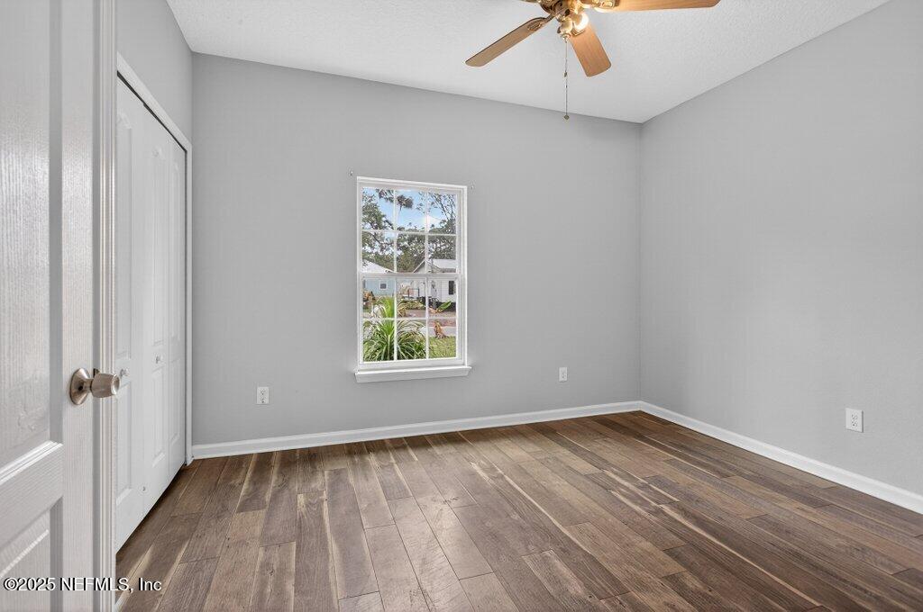 932 Puryear Street St. Augustine, FL 32084 - Photo 13 of 29 wooden floor in an empty room with a window