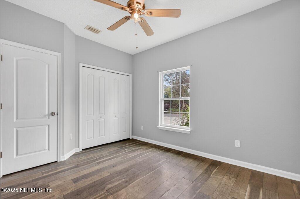 932 Puryear Street St. Augustine, FL 32084 - Photo 16 of 29 an empty room with wooden floor fan and windows