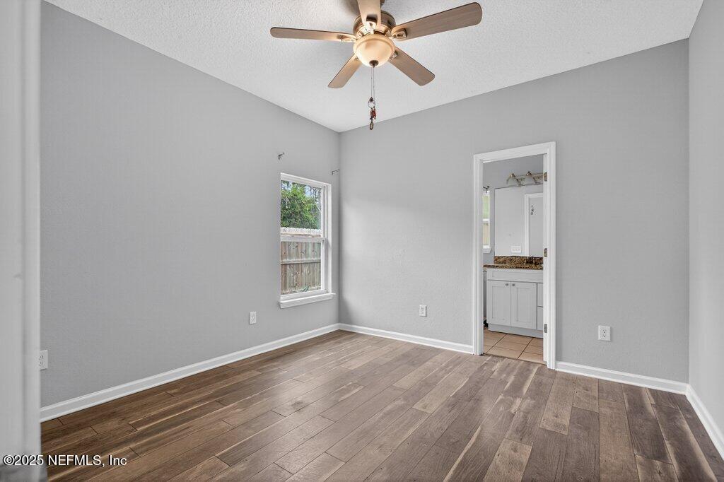 932 Puryear Street St. Augustine, FL 32084 - Photo 18 of 29 wooden floor in an empty room with a window