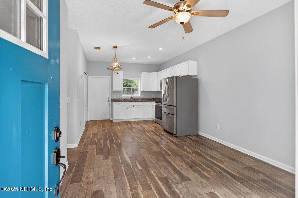 932 Puryear Street St. Augustine, FL 32084 - Photo 3 of 29 a kitchen with stainless steel appliances a refrigerator sink and cabinets