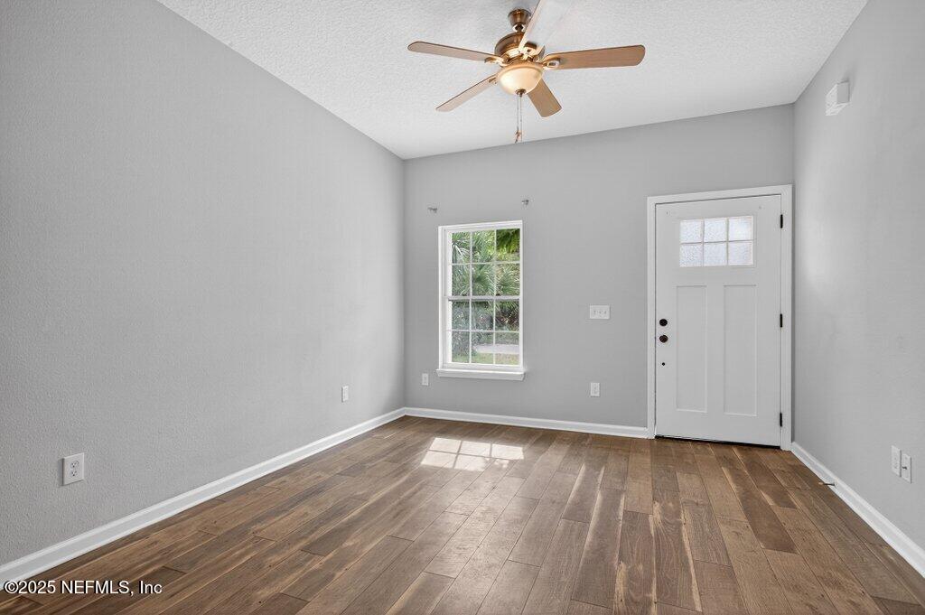 932 Puryear Street St. Augustine, FL 32084 - Photo 4 of 29 a view of empty room with wooden floor and fan