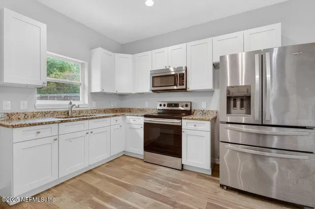 a stove top oven sitting inside of a kitchen