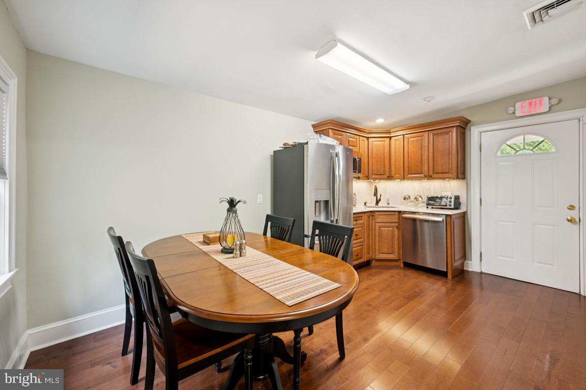 1526 Haddonfield-Berlin Road Cherry Hill, NJ 08003 - Photo 13 of 24 a view of a dining room with furniture and wooden floor