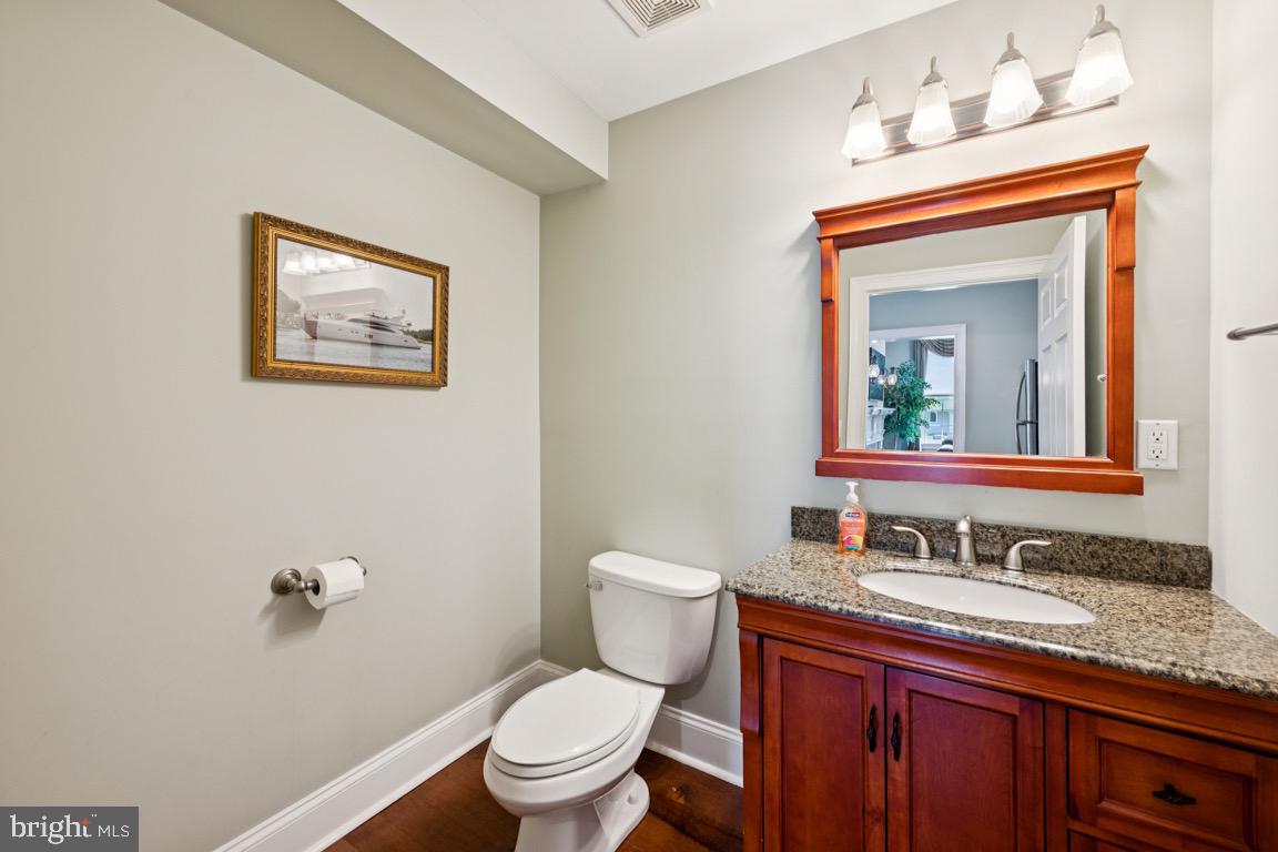 1526 Haddonfield-Berlin Road Cherry Hill, NJ 08003 - Photo 15 of 24 a bathroom with a granite countertop toilet a sink and mirror