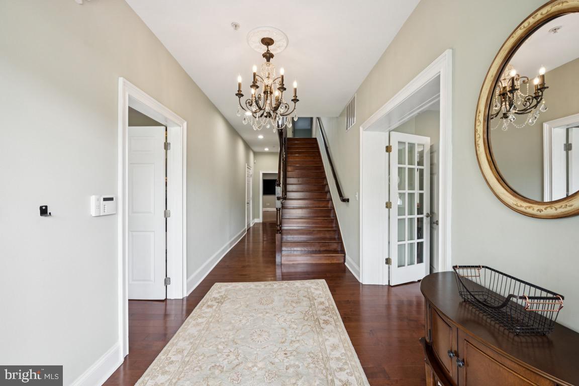 1526 Haddonfield-Berlin Road Cherry Hill, NJ 08003 - Photo 2 of 24 a view of a hallway with wooden floor and staircase