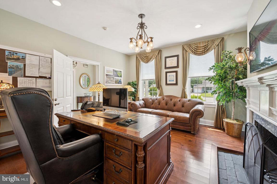 1526 Haddonfield-Berlin Road Cherry Hill, NJ 08003 - Photo 7 of 24 a living room with furniture a fireplace and a chandelier