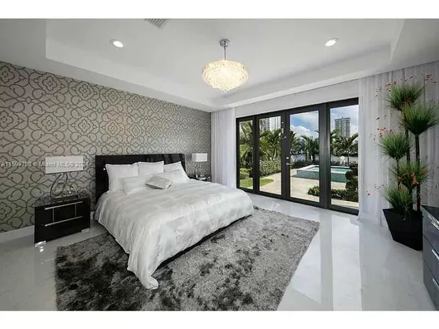 a bedroom with a large bed and a large window