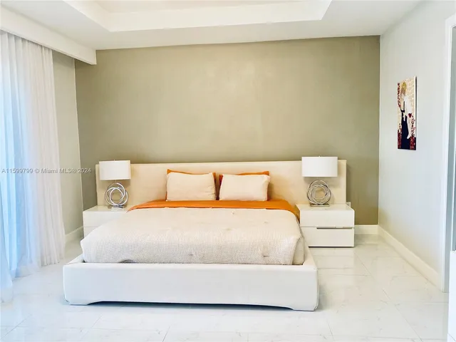 a white bed in a white room