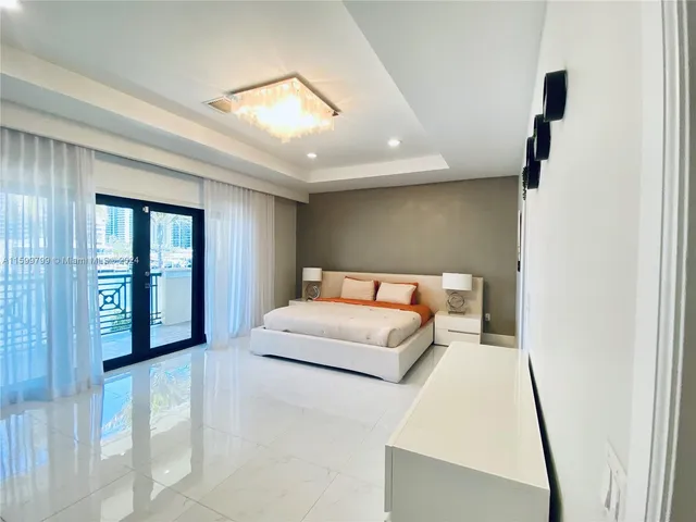 a bedroom with a large bed and a large window