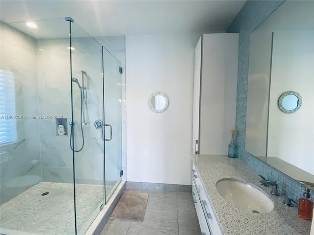 a bathroom with a sink and shower