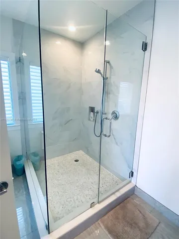 a bathroom with a glass shower door