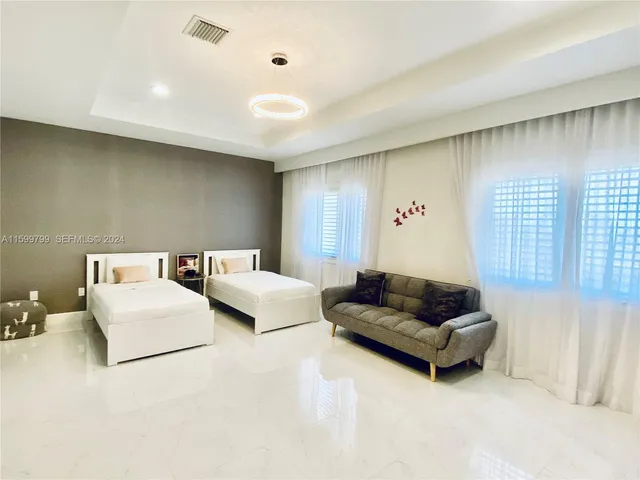 a living room with furniture and a night stand