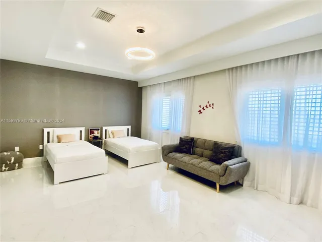 a living room with furniture and a night stand