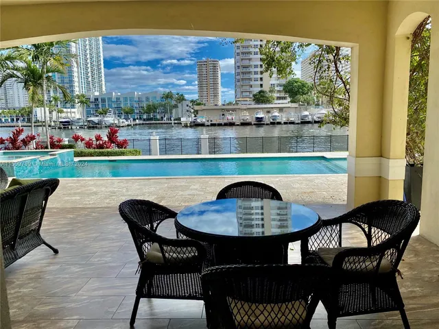 a dining room with furniture and a floor to ceiling window