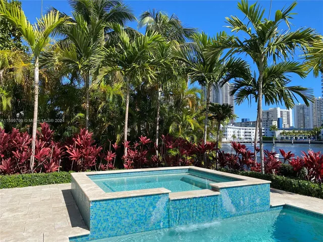 a view of a swimming pool with a patio and a garden
