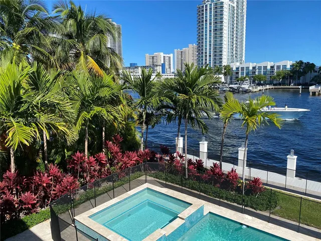 a view of swimming pool with outdoor seating and plants