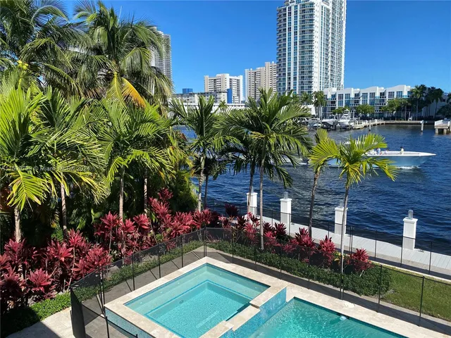 a view of swimming pool with outdoor seating and plants