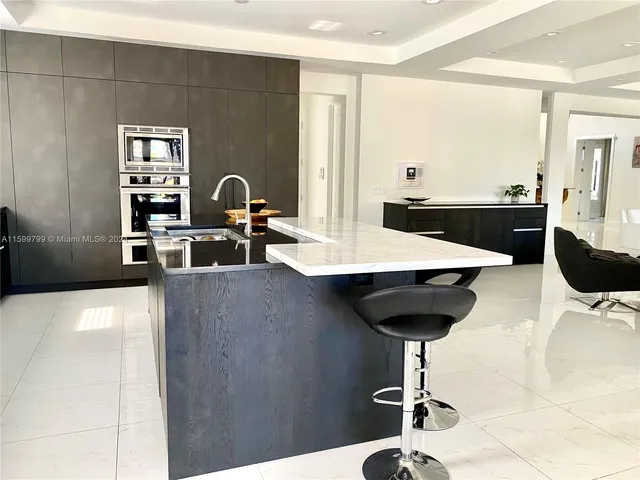 a view of a very nice looking dining room with a table and chairs