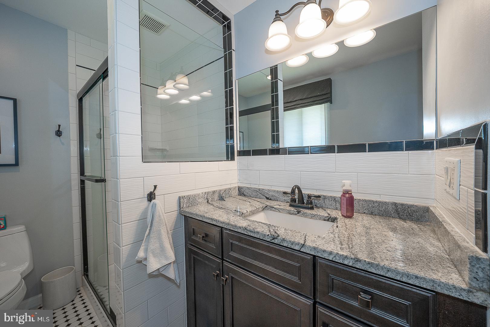 848 Mourning Dove Road Audubon, PA 19403 - Photo 29 of 86 a bathroom with a sink a toilet and a mirror
