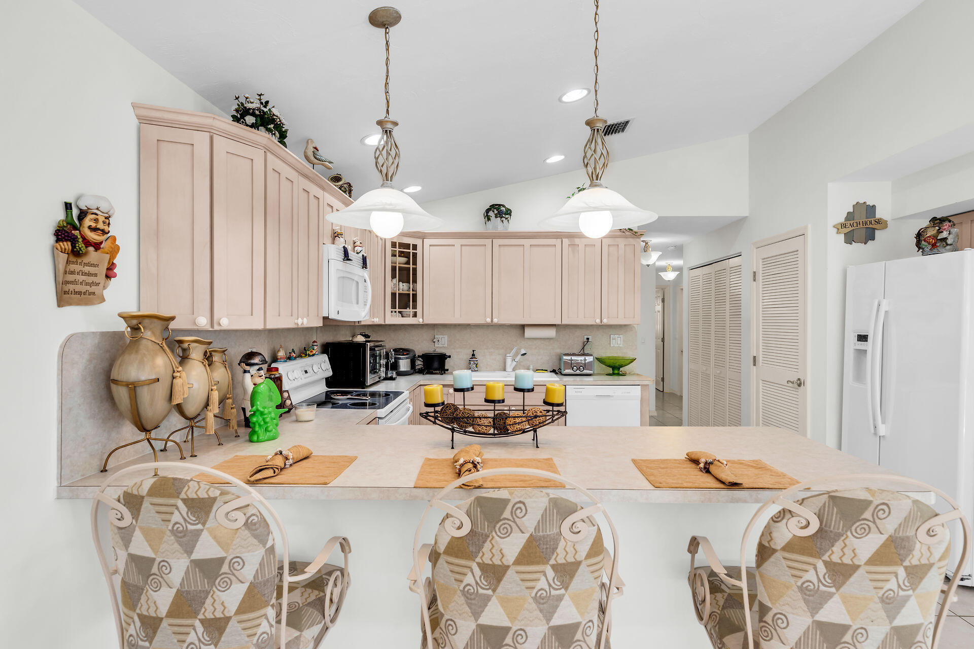 130 9th Street Key Colony Beach, FL 33051 - Photo 11 of 36 a bed room with furniture and a chandelier