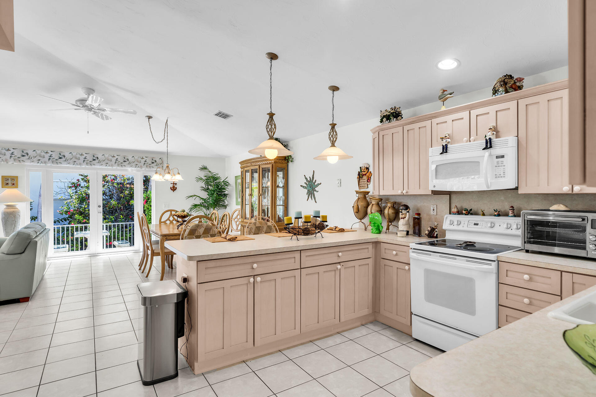 130 9th Street Key Colony Beach, FL 33051 - Photo 12 of 36 a kitchen with a sink stove and cabinets