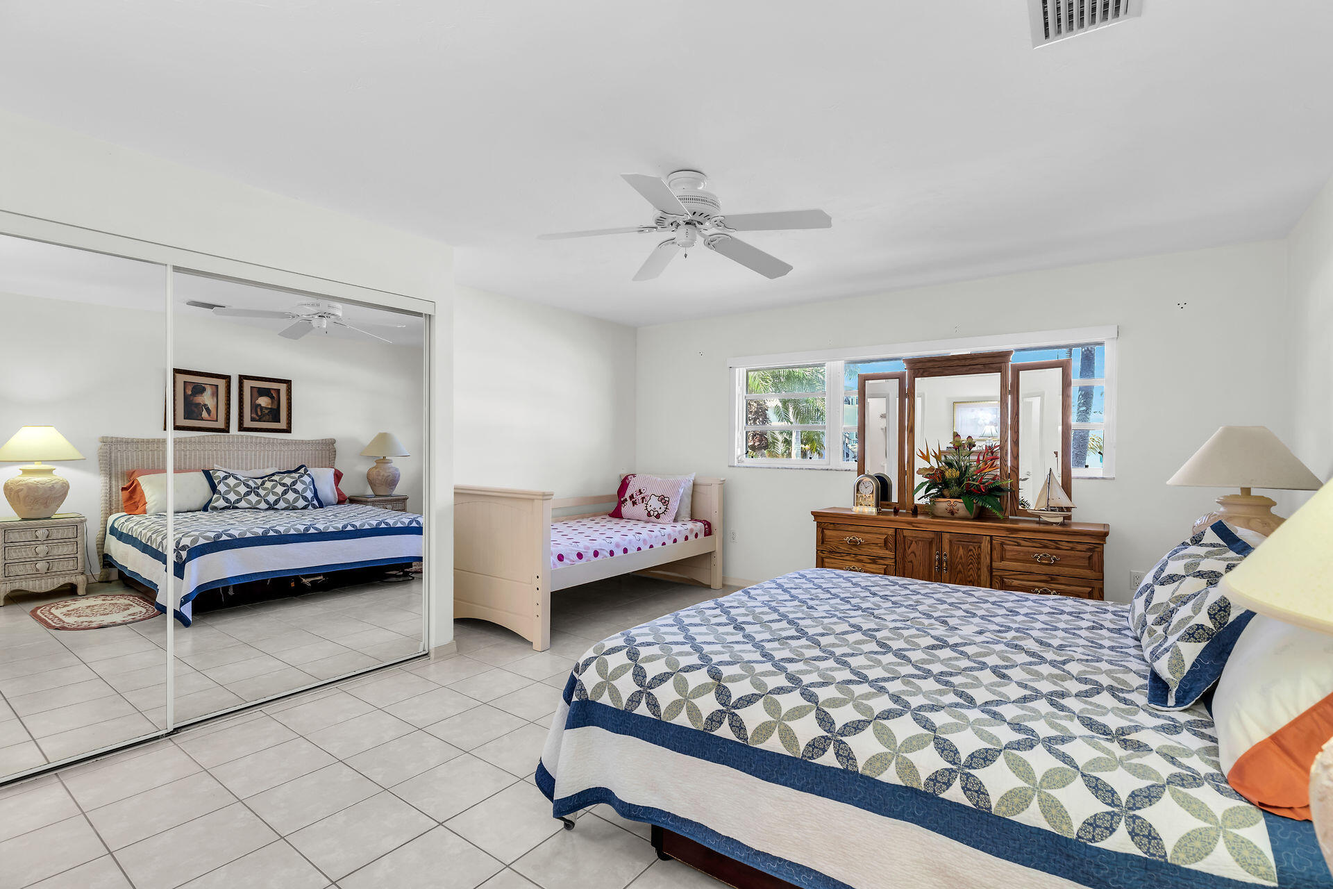 130 9th Street Key Colony Beach, FL 33051 - Photo 14 of 36 a bedroom with furniture and a chandelier