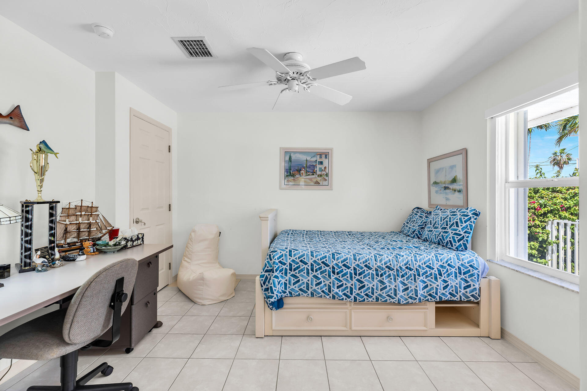 130 9th Street Key Colony Beach, FL 33051 - Photo 25 of 36 a bedroom with a bed and a chandelier