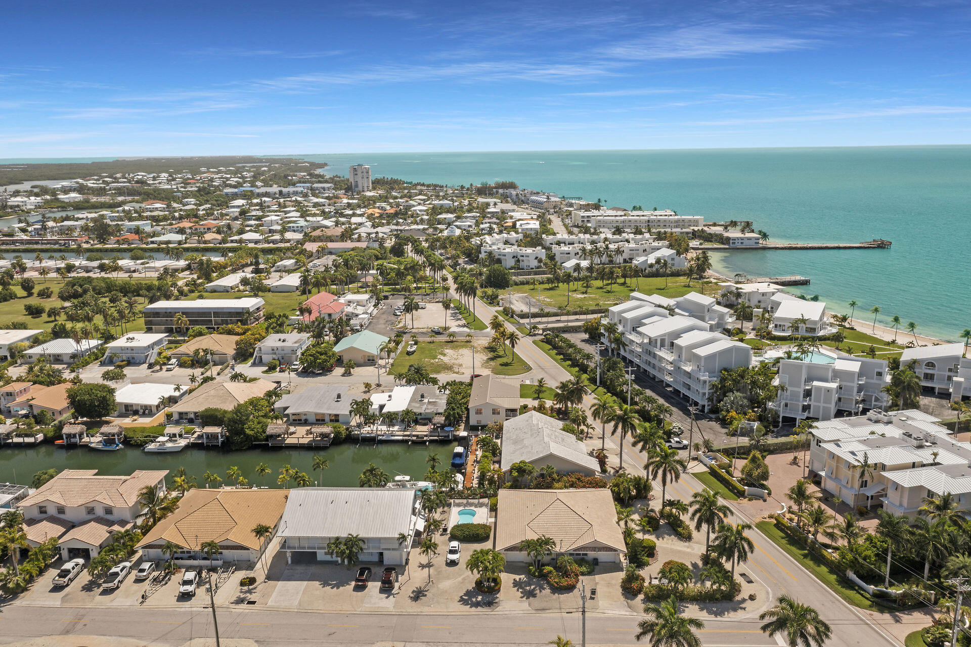 130 9th Street Key Colony Beach, FL 33051 - Photo 30 of 36 an aerial view of a city with lots of residential buildings ocean and mountain view in back