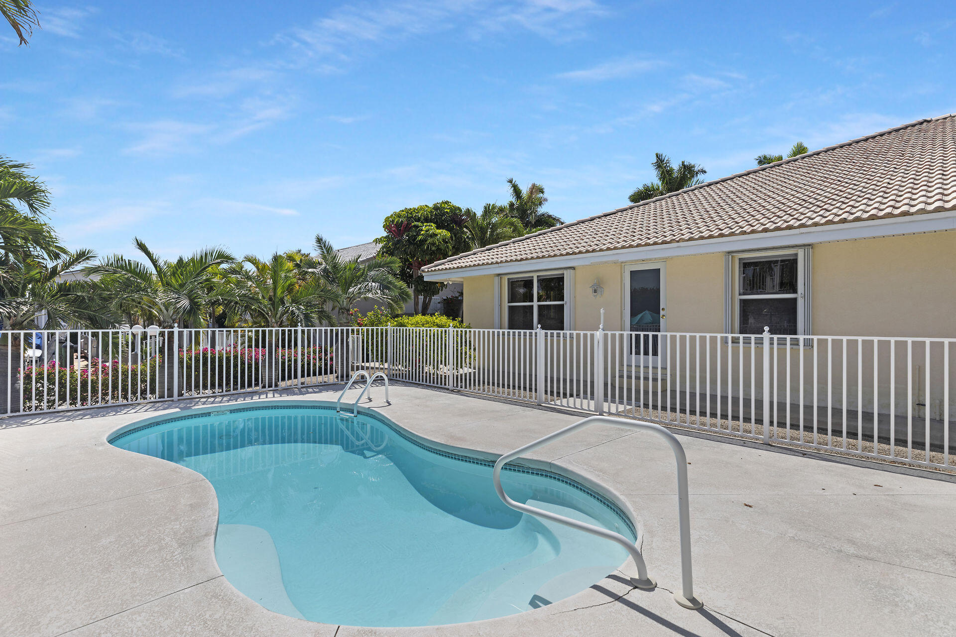 130 9th Street Key Colony Beach, FL 33051 - Photo 34 of 36 a view of a house with swimming pool and wooden fence
