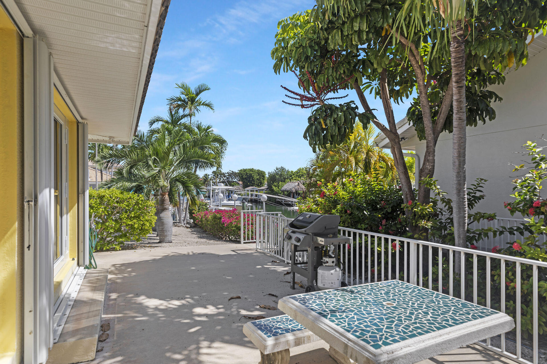 130 9th Street Key Colony Beach, FL 33051 - Photo 5 of 36 a view of a porch with a table and chairs