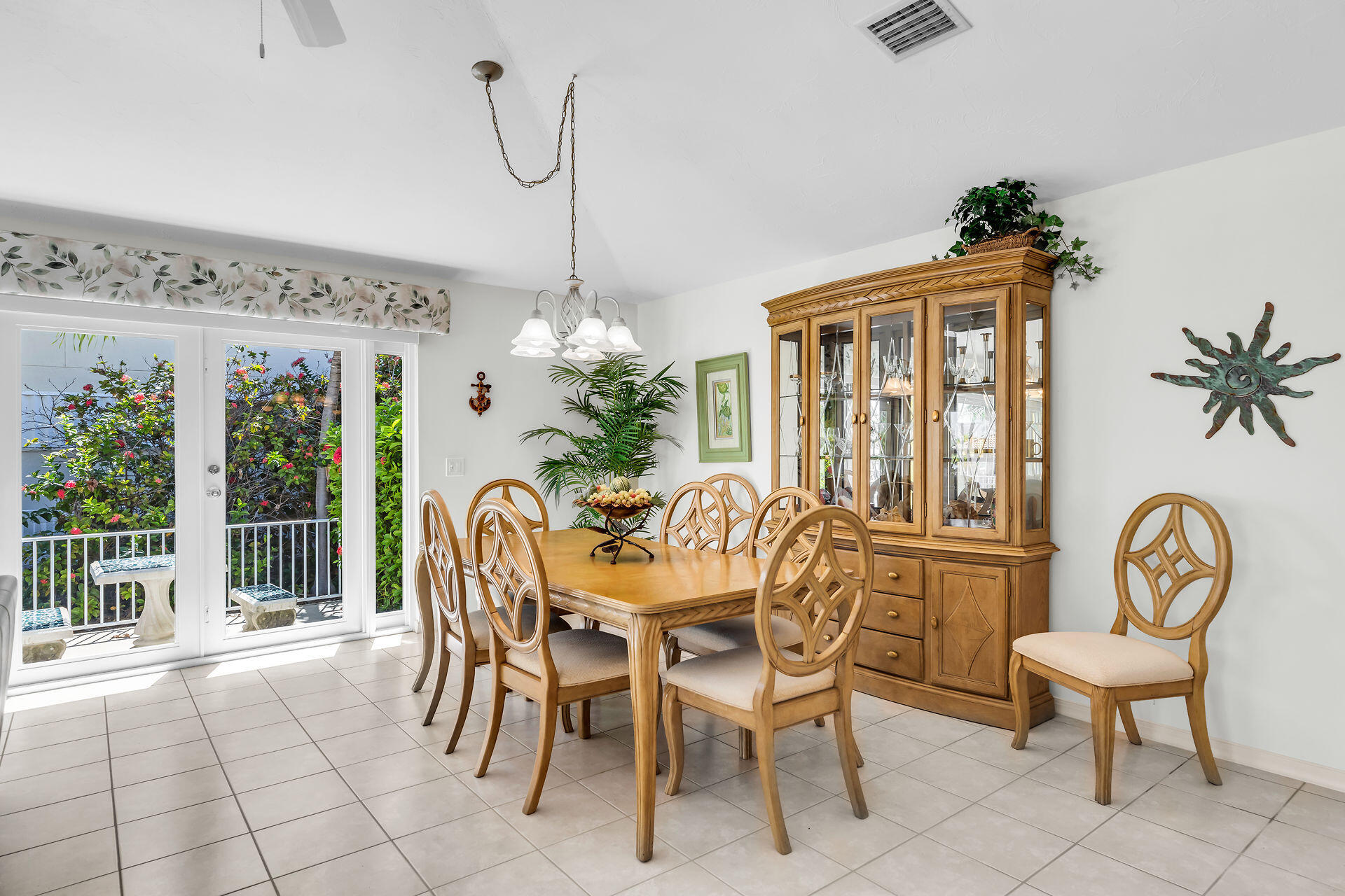 130 9th Street Key Colony Beach, FL 33051 - Photo 9 of 36 a dining room with furniture a potted plant and a chandelier