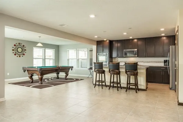 a living room with dining room and kitchen view