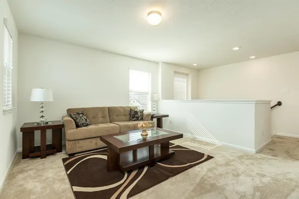 a living room with furniture and a lamp