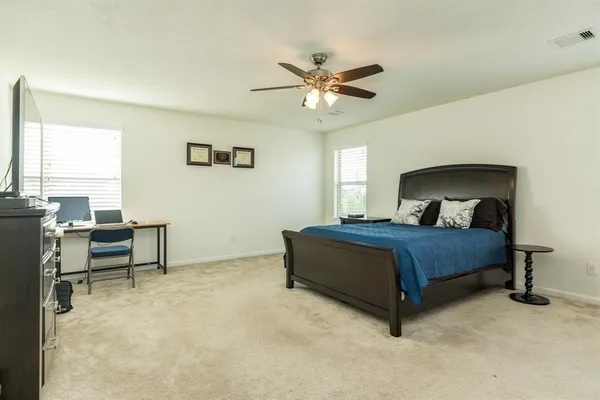 a bedroom with a bed and a chandelier