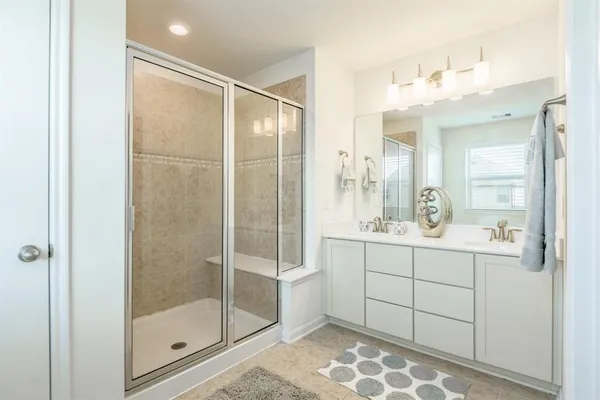 a bathroom with a shower and a sink
